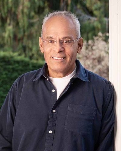 A. Paul Singh, Registered Social Worker (RSW) outside, leaning against a post